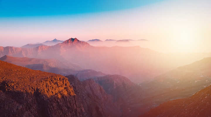 A view of the majestic Jebel Jais mountain in Ras Al Khaimah, United Arab Emirates from the highest viewing area during sunset.